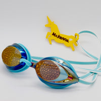 Yellow unicorn shaped Swim Loops goggle tag to label swim goggles with name written on it attached to swim goggles