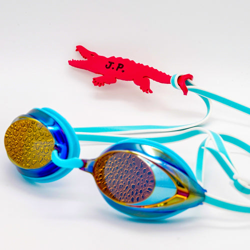 Alligator shaped goggle tag to identify your goggles when you leave them on the pool deck. Get your Swim Loops goggle tags at www.swimloops.com.