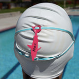 Dark pink shark shaped Swim Loops goggle tag to label swim goggles attached to swim goggles on swimmers head