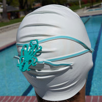Sea foam green octopus shaped Swim Loops goggle tag to label swim goggles attached to swim goggles on swimmers head